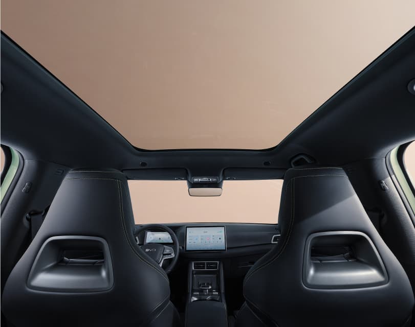 BYD ATTO 2 panoramic sunroof — airy cabin with ambient lighting and wireless charging